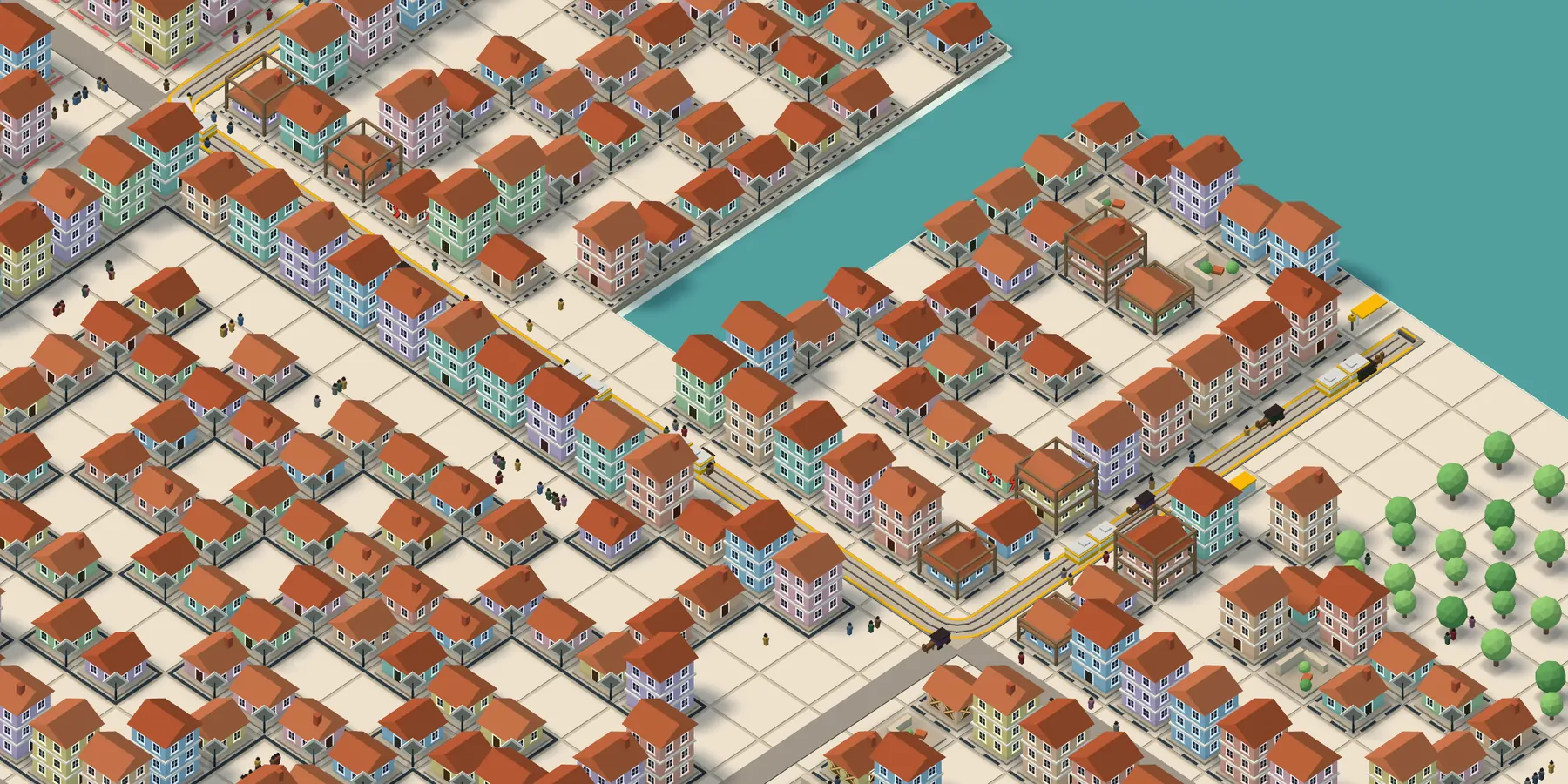 La grande ville de Game Of Town : la ligne de tram T1 court dans les rues entre des quartiers de maisons colorées, longe la forêt et la mer